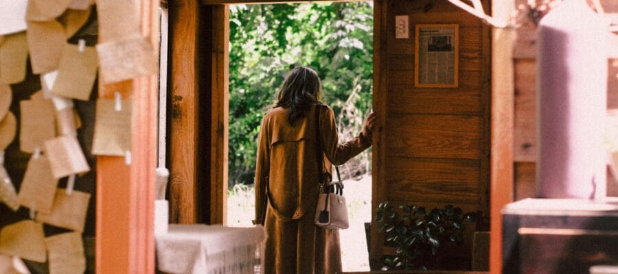 Woman Standing Near Open Door About to Step Outside
