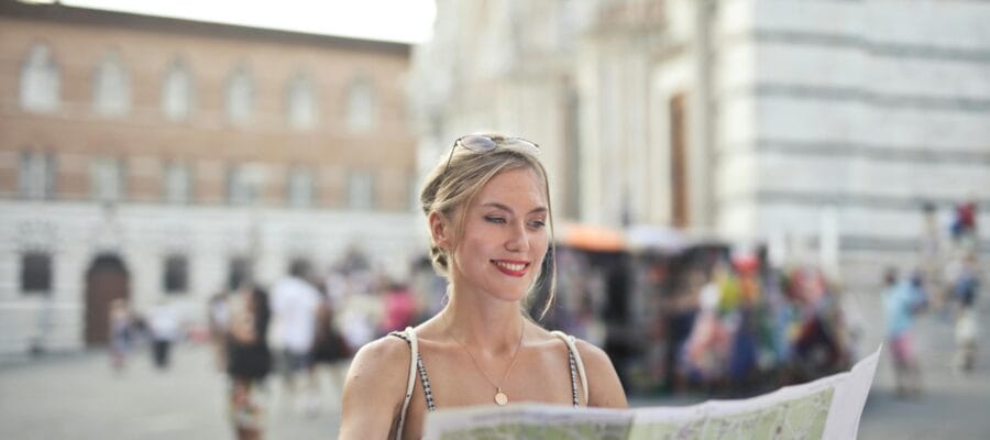 Woman Holding A Map Looking For Next Destination