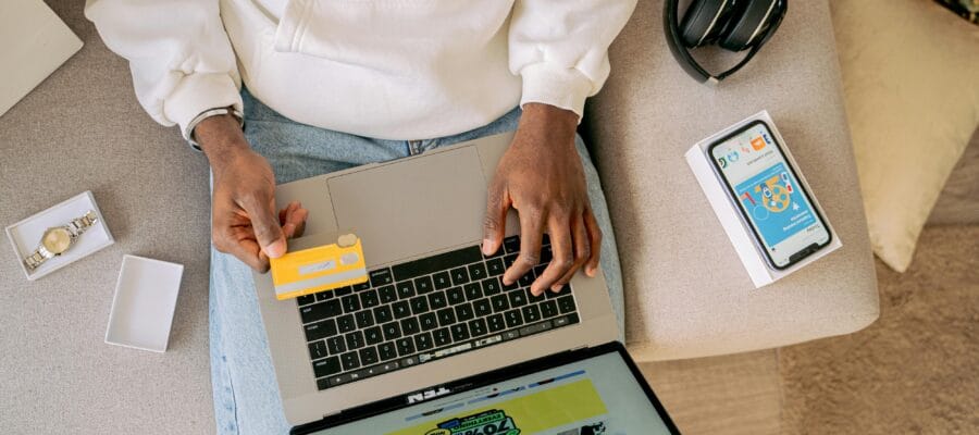 Woman Sitting on a Couch and Online Shopping